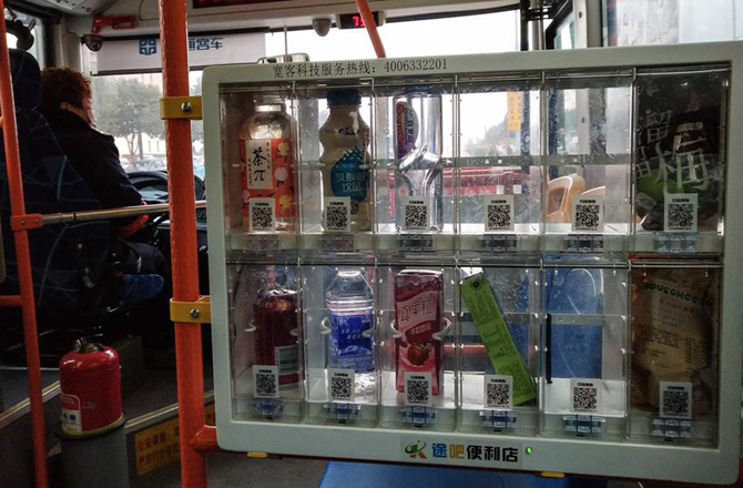 乘客通过手机扫描二维码支付，可以在公交车上购买食品。（图片来源：东方IC）