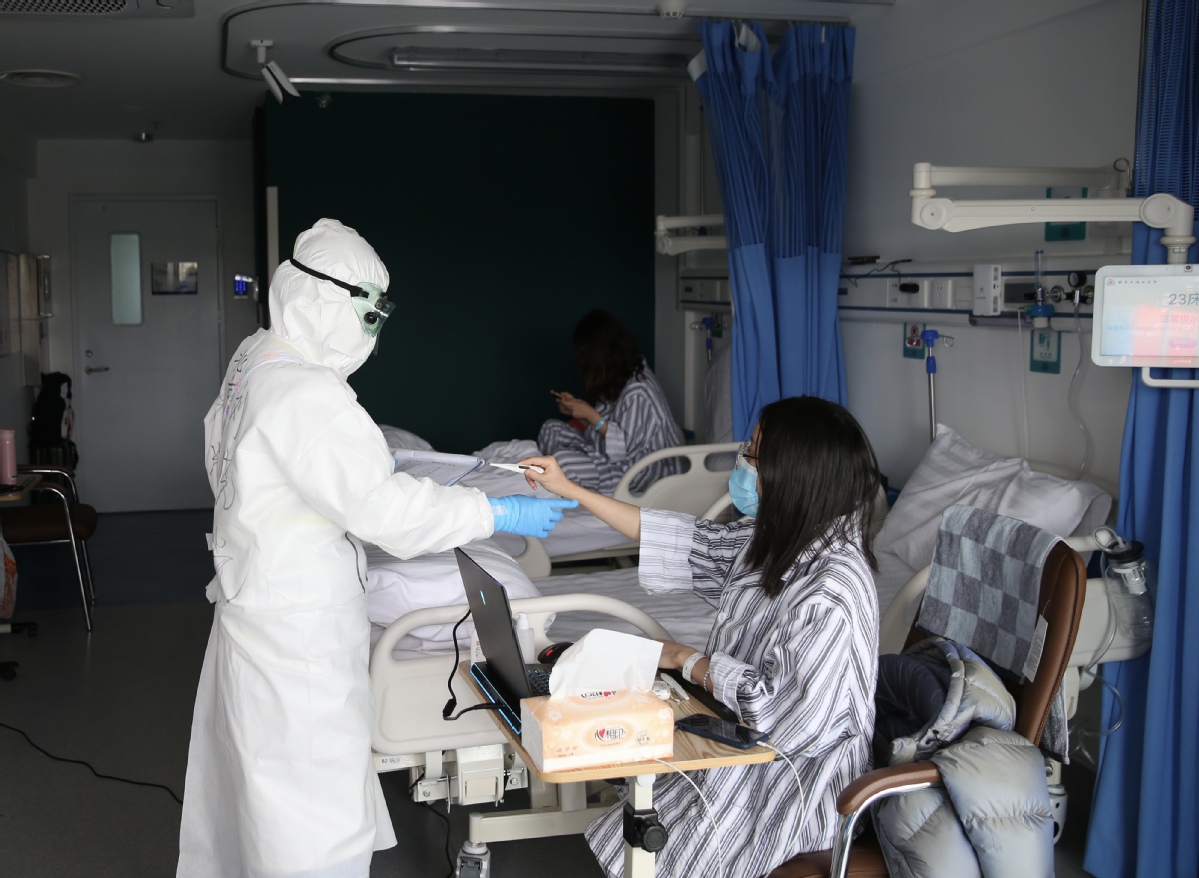 3月30日,北京小汤山定点医院病房区,确诊病区护士给患者做体温监测